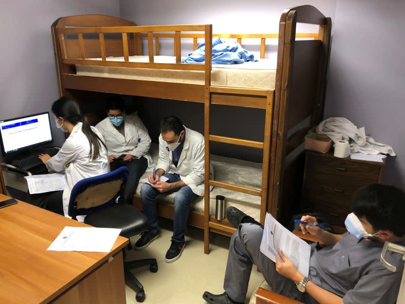 Health workers sit together inside Saint George Hospital University Medical center, in Beirut