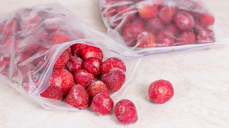 Two Ziploc bags of frozen strawberries