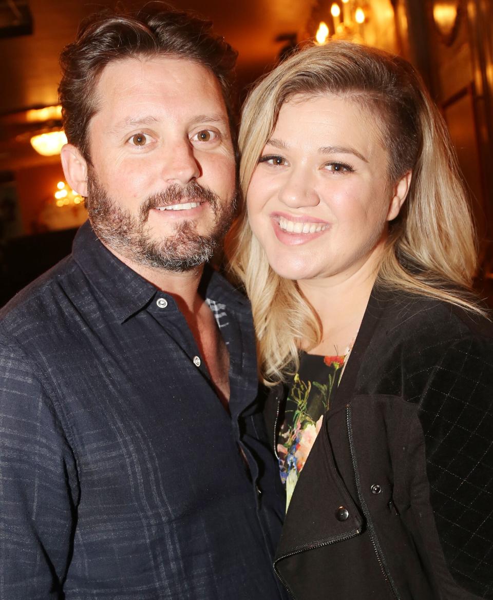 Brandon Blackstock and wife Kelly Clarkson pose backstage at the hit musical "Finding Neverland" on Broadway at The Lunt Fontanne Theater on July 15, 2015 in New York City