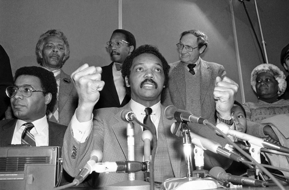 FILE - Rev. Jesse Jackson, candidate for the democratic presidential nomination, gestures with clenched fists as he speaks to reporters during a brief stopover at Logan Airport in Boston, Friday, Jan. 7, 1984. Jackson plans to step down from leading the Chicago civil rights organization Rainbow PUSH Coalition he founded in 1971, his son's congressional office said Friday, July 14, 2023. (AP Photo/Vince Dewit. File)