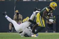 Green Bay Packers' Davante Adams gets past Detroit Lions' Jamie Collins during the second half of an NFL football game Monday, Sept. 20, 2021, in Green Bay, Wis. (AP Photo/Mike Roemer)