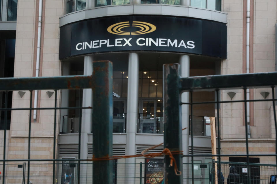 A Cineplex movie theatre sign is seen over a construction gate on Yonge street in Toronto, Ontario, Canada March 16, 2020.  REUTERS/Chris Helgren