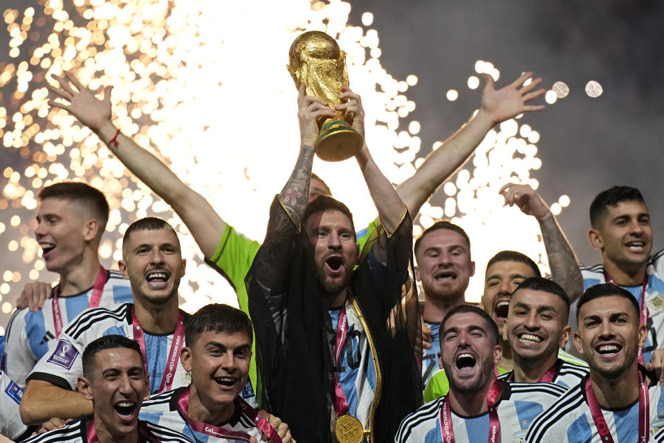 Argentina's Lionel Messi lifts the trophy after winning the World Cup final soccer match between Argentina and France at the Lusail Stadium in Lusail, Qatar, Sunday, Dec. 18, 2022. Argentina won 4-2 in a penalty shootout after the match ended tied 3-3. (AP Photo/Martin Meissner)