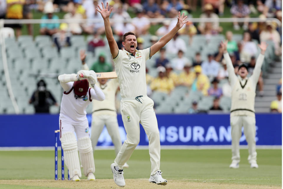 Australia's Josh Hazlewood, center, appeals for a LBW decision on West Indies Tagenarine Chanderpaul, left, on the first day of their cricket test match in Adelaide, Australia, Wednesday, Jan. 17, 2024. (AP Photo/James Elsby)