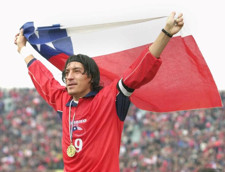 Chilean star soccer player Ivan Zamorano holds a Chilean flag after defeating France's national soccer team 2-1 in Santiago