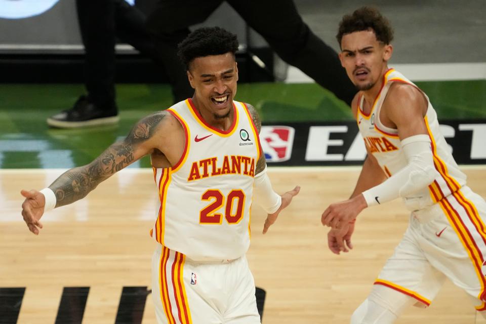 John Collins (20) and Trae Young have developed great on-court chemistry, which has helped the Hawks reach the Eastern Conference finals.