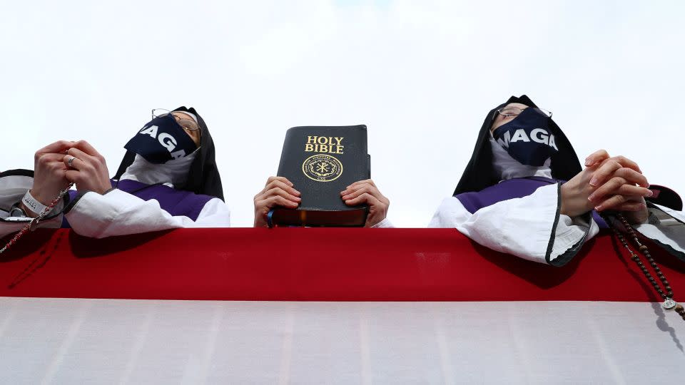 Supporters hold the Holy Bible as President Donald Trump speaks during a campaign event at the Pickaway Agriculture and Event Center in Circleville, Ohio, on October 24, 2020. - Tom Brenner/Reuters