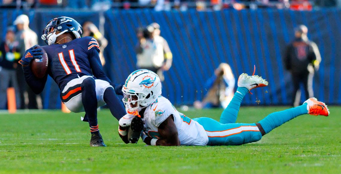 Miami Dolphins cornerback Kader Kohou (28) tackles Chicago Bears wide receiver Darnell Mooney (11) during fourth quarter of an NFL football game at Soldier Field on Sunday, November 6, 2022 in Chicago, Illinois.