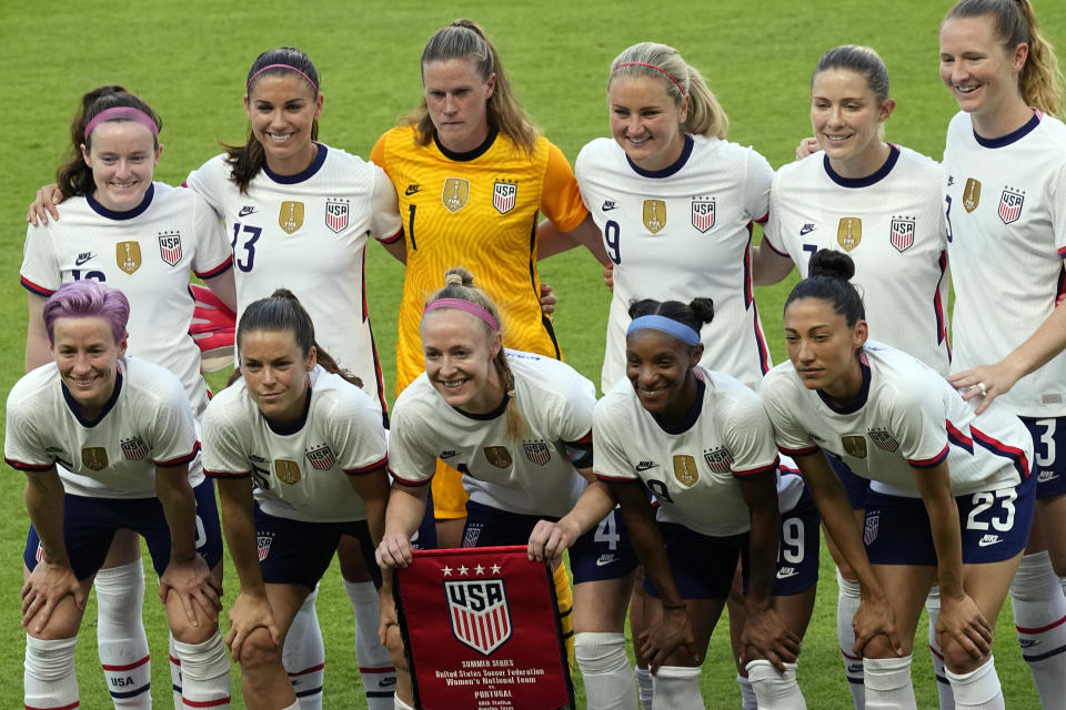 FILE - In this Thursday, June 10, 2021 file photo, the United States women's national soccer team starters pose for photographers before an international friendly soccer match against Portugal, in Houston. On Friday, July 9, 2021, The Associated Press reported on stories circulating online incorrectly asserting players on the U.S. women’s national soccer team “turned their backs” on a World War II veteran playing the national anthem at a game Monday. “Not true. No one turned their back on WWII Veteran Pete DuPré during tonight’s anthem,” the U.S. soccer communications team tweeted on Monday night. “Some USWNT players were simply looking at the flag on a pole in one end of the stadium. The players all love Pete, thanked him individually after the game and signed a ball for him.” (AP Photo/David J. Phillip, File)