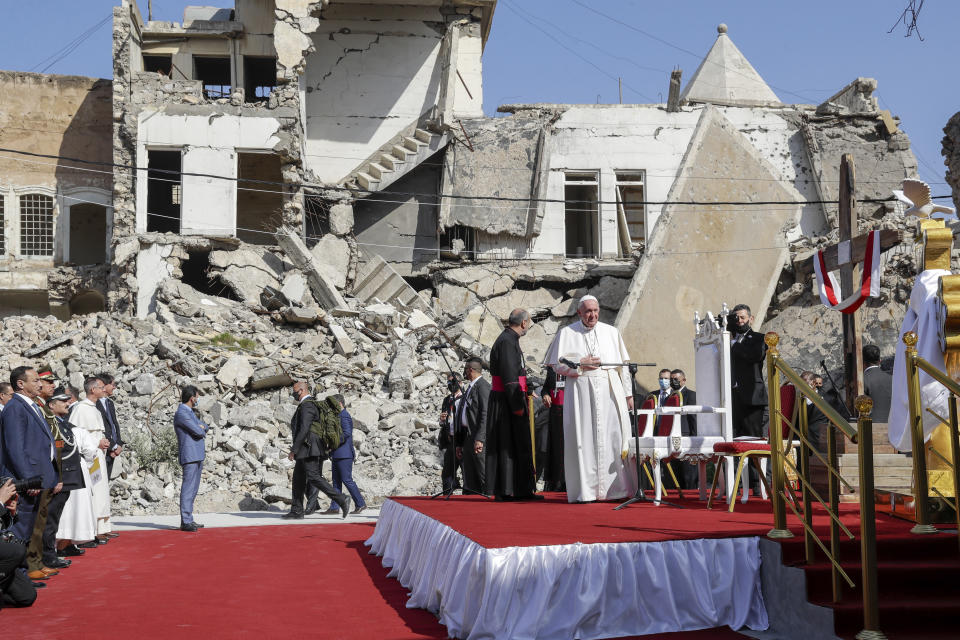 Pope Francis, surrounded by shells of destroyed churches, arrives to pray for the victims of war at Hosh al-Bieaa Church Square, in Mosul, Iraq, once the de-facto capital of IS, Sunday, March 7, 2021. The long 2014-2017 war to drive IS out left ransacked homes and charred or pulverized buildings around the north of Iraq, all sites Francis visited on Sunday. (AP Photo/Andrew Medichini)