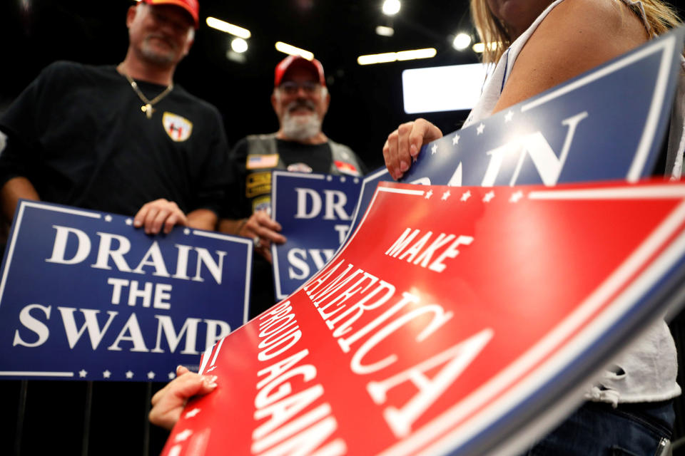 A volunteer hands out signs