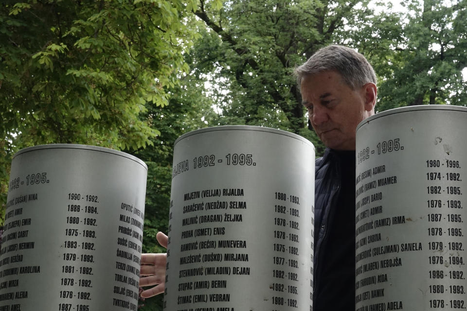 Fikret Grabovica who lost his 11-year-old daughter by Bosnian Serb shelling look at the names at the memorial for children killed during 1002-1995 siege, in Sarajevo, Bosnia, Monday, May 31, 2021. U.N. judges on Tuesday, June 8 deliver their final ruling on the conviction of former Bosnian Serb army chief Radko Mladic on charges of genocide, war crimes and crimes against humanity during Bosnia’s 1992-95 ethnic carnage. Nearly three decades after the end of Europe’s worst conflict since World War II that killed more than 100,000 people, a U.N. court is set to close the case of the Bosnian War’s most notorious figure. (AP Photo/Eldar Emric)