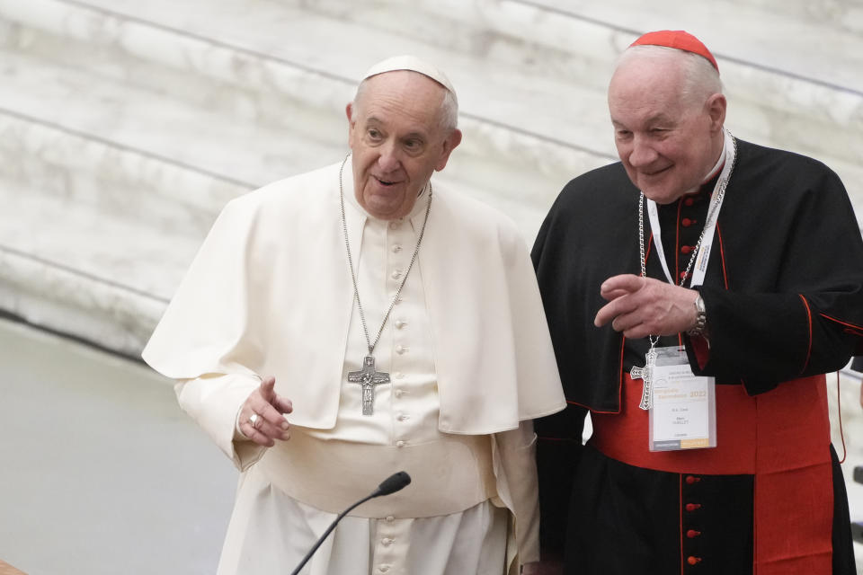 Pope Francis, left, and Cardinal Marc Ouellet arrive at the opening of a 3-day Symposium on Vocations in the Paul VI hall at the Vatican, Thursday, Feb. 17, 2022. (AP Photo/Gregorio Borgia)