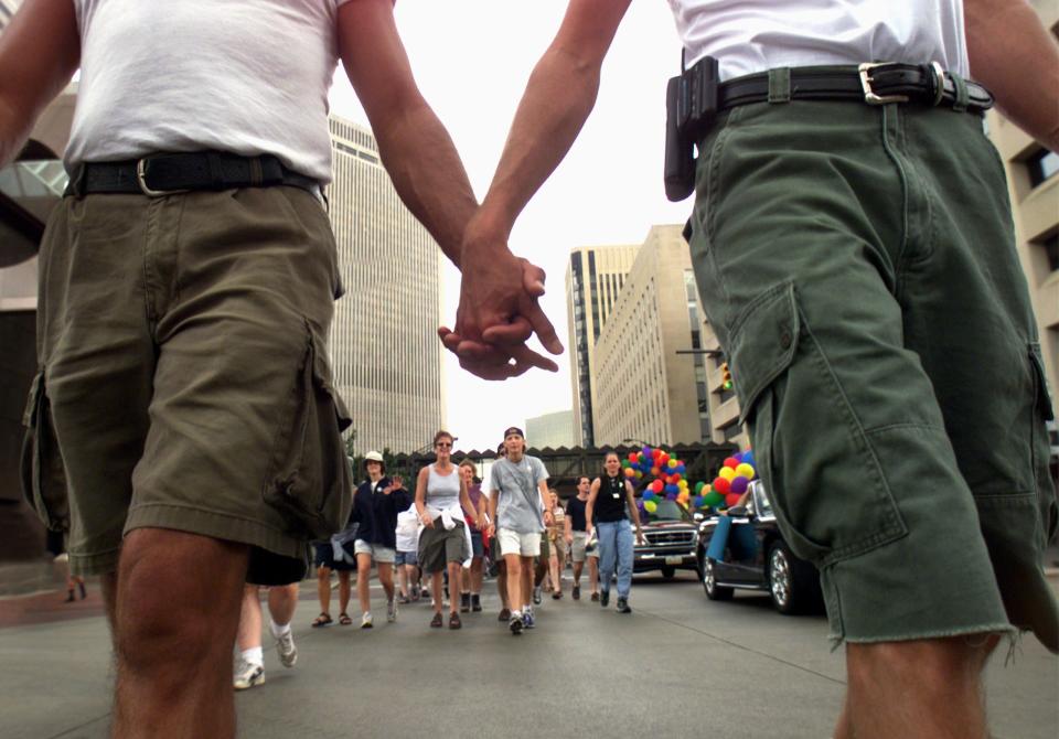 Lovers and friends walked hand in hand down High Street in celebration of Gay Pride.