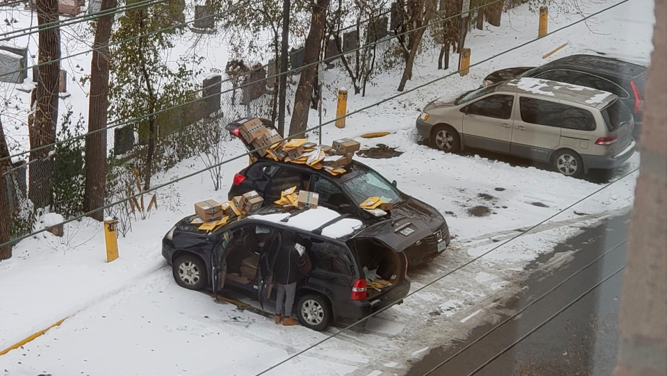 A photo by Don Turton shows Amazon packages piled up on the vehicles in his building’s parking lot. (Don Turton)