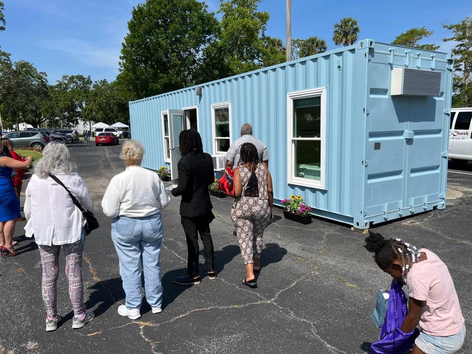 Attendees of the Housing Fair & Financial Wellness Clinic at Allen Chapel AME Church in Daytona Beach on Saturday, April 29, 2023, check out a shipping container converted into a modular home by Snap Space Solutions. Prices start at $69,900, according to the Ormond Beach company's website. The event was put on by the church, Mid-Florida Housing Partnership, the City of Daytona Beach and Daytona Beach Area Association of Realtors to mark the anniversary of the signing of the federal Fair Housing Act in April 1968.