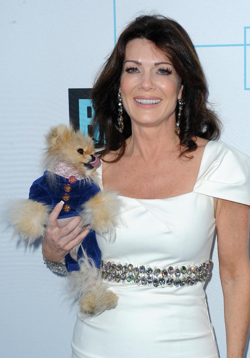 FILE - In this March 30, 2011 file photo, Lisa Vanderpump from "The Real Housewives of Beverly Hills," arrives at the Bravo Media's 2011 upfront presentation with her dog Giggy, at The Roosevelt Hotel in Los Angeles, Calif. Bravo announced at its upfront presentation Wednesday, April 4, 2012, that Vanderpump will get her own reality show centered around the inner-workings of her new Hollywood restaurant, SUR. (AP Photo/Katy Winn, file)