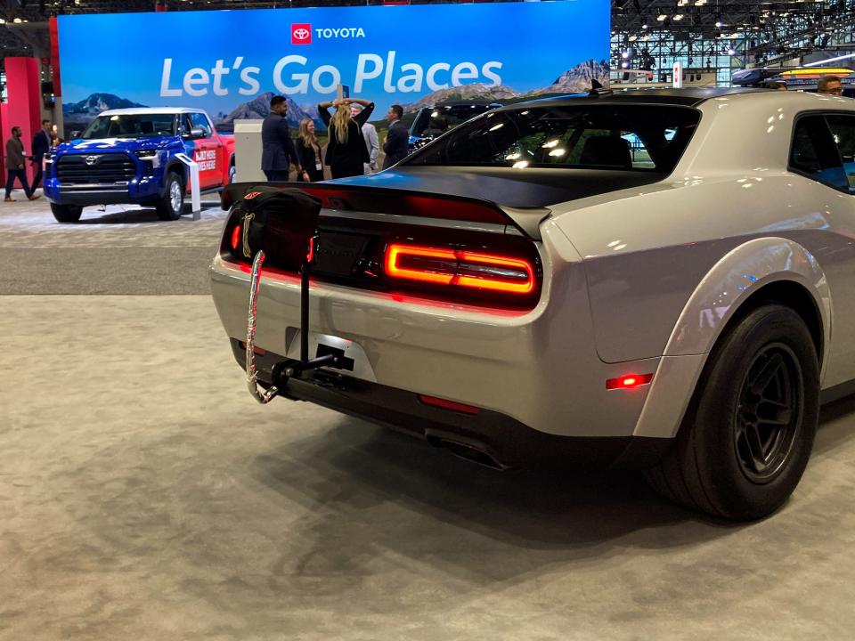 The rear brake lights light up in red on the silver Dodge Challenger SRT Demon 170.