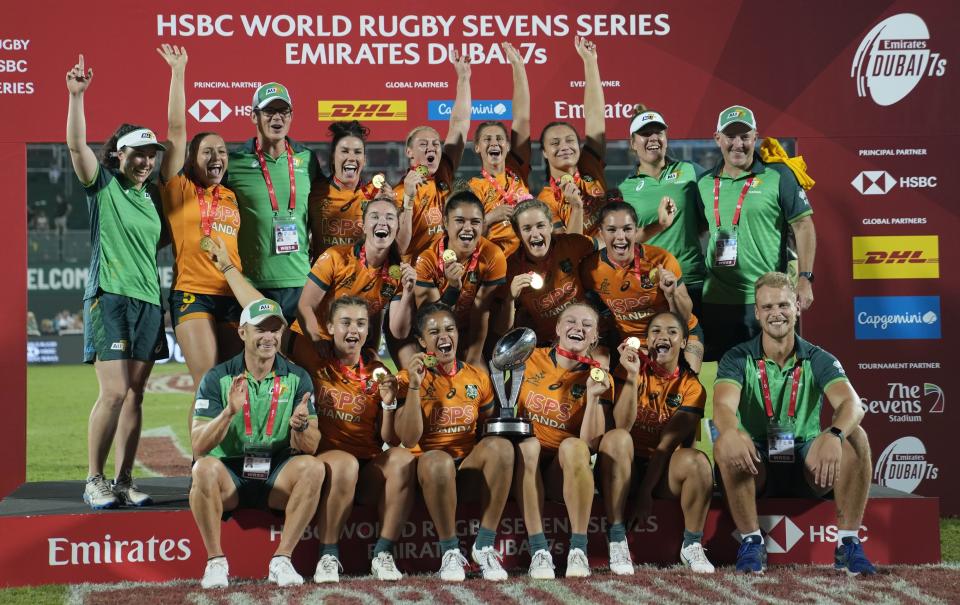 Australia players celebrate with their trophy after they beat New Zealand during the final match of the Emirates Airline Rugby Sevens, in Dubai, United Arab Emirates, Saturday, Dec. 3, 2022. (AP Photo/Kamran Jebreili)