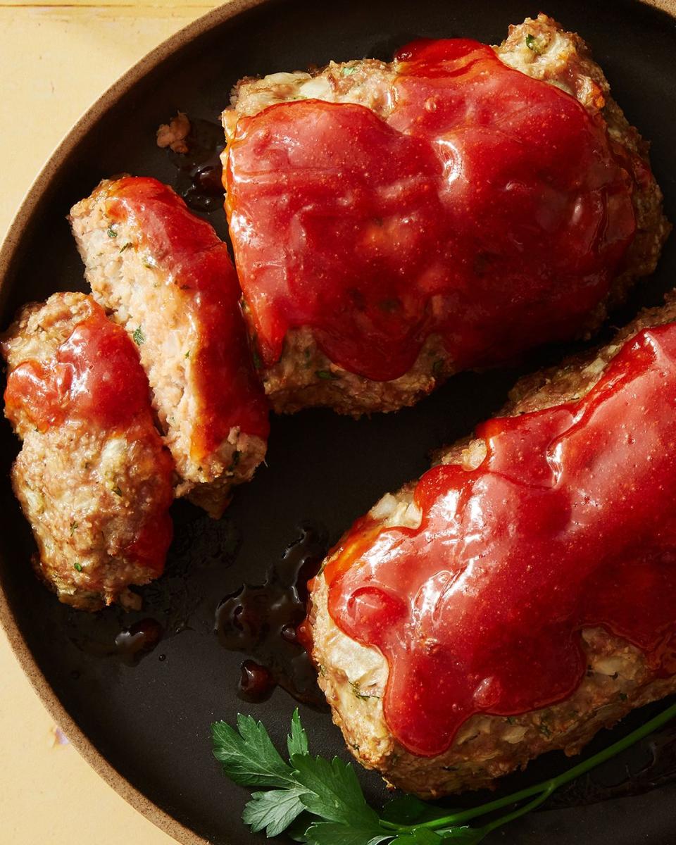 air fryer turkey meatloaf topped with ketchup on a black plate