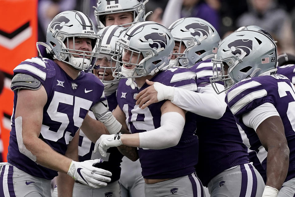 Kansas State linebacker Cody Fletcher (55) celebrates with teammates after he intercepted a pass during the second half of an NCAA college football game against West Virginia, Saturday, Nov. 13, 2021, in Manhattan, Kan. (AP Photo/Charlie Riedel)