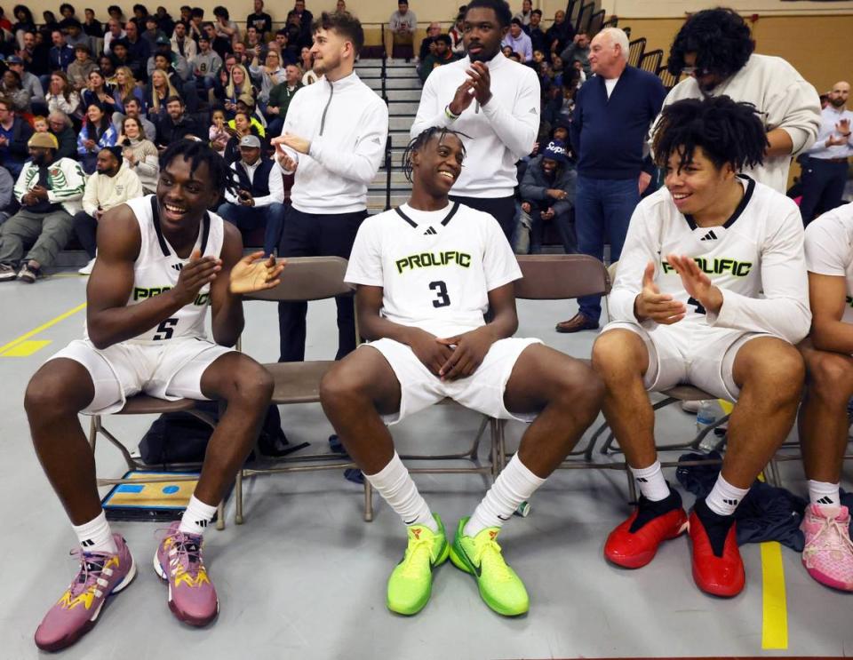 Prolific Prep’s AJ Dybantsa, center, with teammates from left, Zoom Diallo and Tyran Stokes, share a laugh before a game against Orangeville Prep on Wednesday, Jan. 10, 2024.