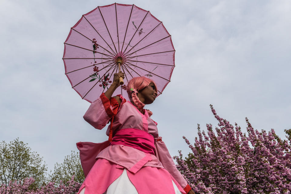 Woman holding parisol at Lolita-style fashion show