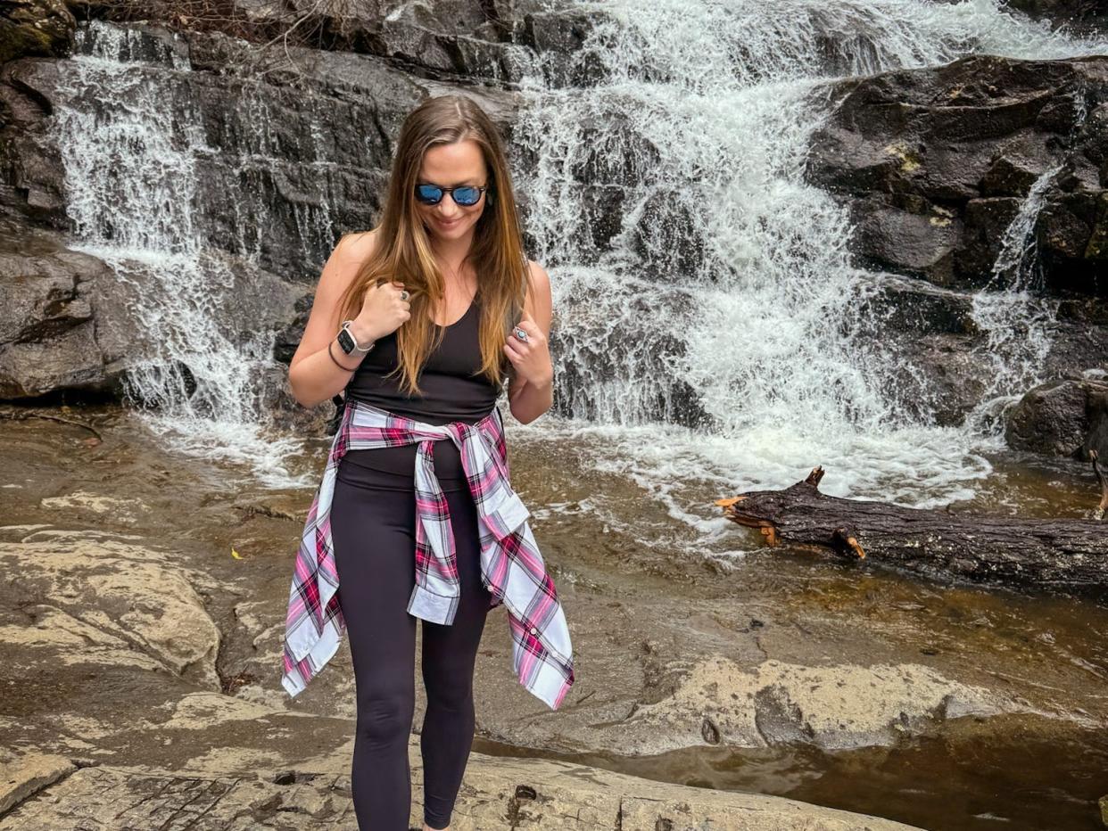 Emily standing in front of a waterfall at Great Smoky Mountains National Park.