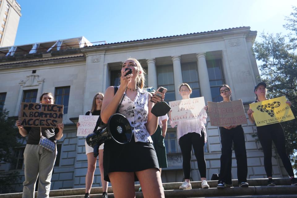 Maya Mackey, an undergraduate at the University of Texas, speaks to students during Thursday's walkout.