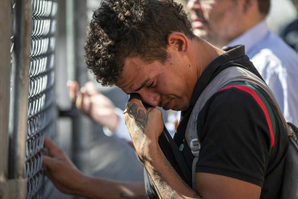 Venezuelan migrant Said Jose wipes his tears while looking for his girlfriend who he was separated from while in detention, at the Sacred Heart Church shelter in El Paso, Texas, Friday, May 12, 2023. The border between the U.S. and Mexico was relatively calm Friday, offering few signs of the chaos that had been feared following a rush by worried migrants to enter the U.S. before the end of pandemic-related immigration restrictions. (AP Photo/Andres Leighton)