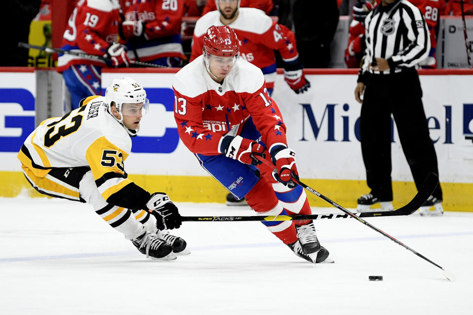 Washington Capitals left wing Jakub Vrana (13) skates with the puck next to Pittsburgh Penguins center Teddy Blueger (53) during the first period of an NHL hockey game, Sunday, Feb. 2, 2020, in Washington. (AP Photo/Nick Wass)