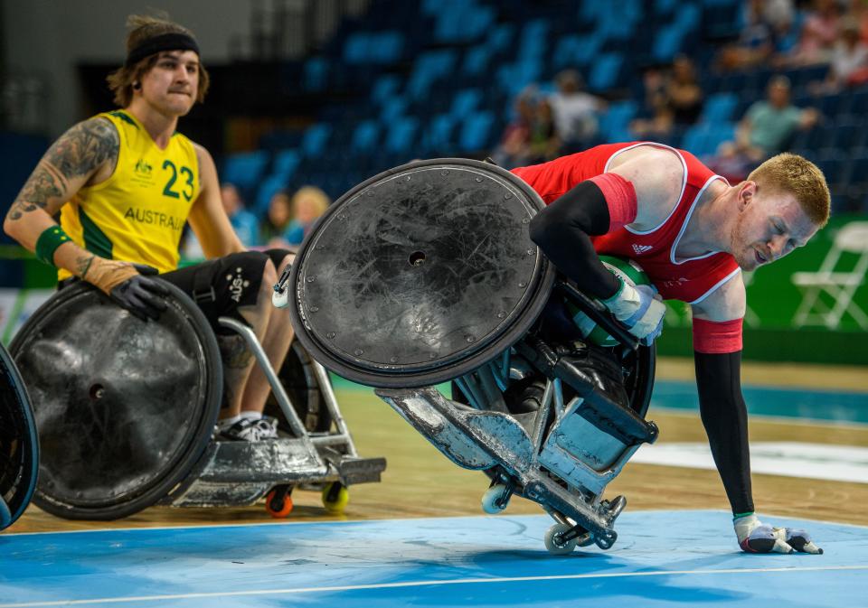 TOPSHOT - Jim Roberts GBR goes into the scoring zone with the ball on one wheel in the Australia vs Great Britain Pool Phase Group A, Match 01 Wheelchair Rugby at the Carioca Arena 1, during the Paralympic Games, in Rio de Janeiro, Brazil, on September 14, 2016. Photo by Bob Martin/OIS/IOC via AFP. RESTRICTED TO EDITORIAL USE / AFP / Bob Martin for OIS/IOC        (Photo credit should read BOB MARTIN FOR OIS/IOC/AFP via Getty Images)