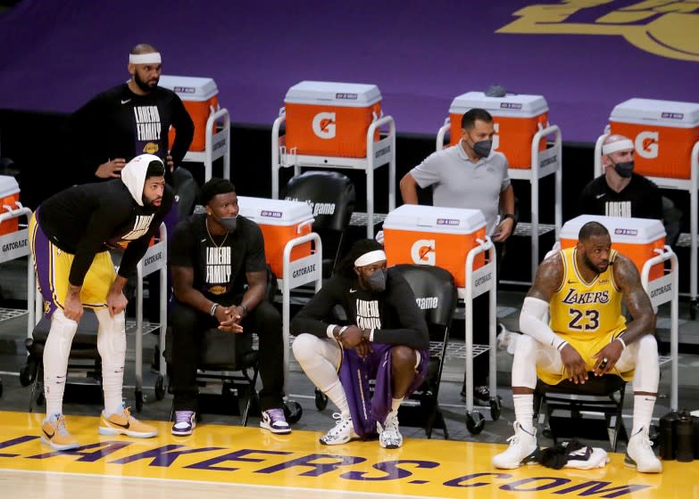 LOS ANGELES, CA - JUNE 03:. Lakers stars LeBron James, right, and Anthony Davis, left, watch the Lakers struggle against the Suns during a 113-100 loss at Staples Center on Thursday, June 3, 2021. The defending champion Lakers have been eliminated from the playoffs. (Luis Sinco / Los Angeles Times)