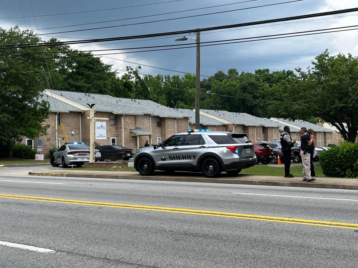 Officials investigate where a Richmond County Sheriff's deputy was shot during a traffic stop at Charlestown South Apartments off Lumpkin Road in south Augusta on Thursday, May 26, 2022.