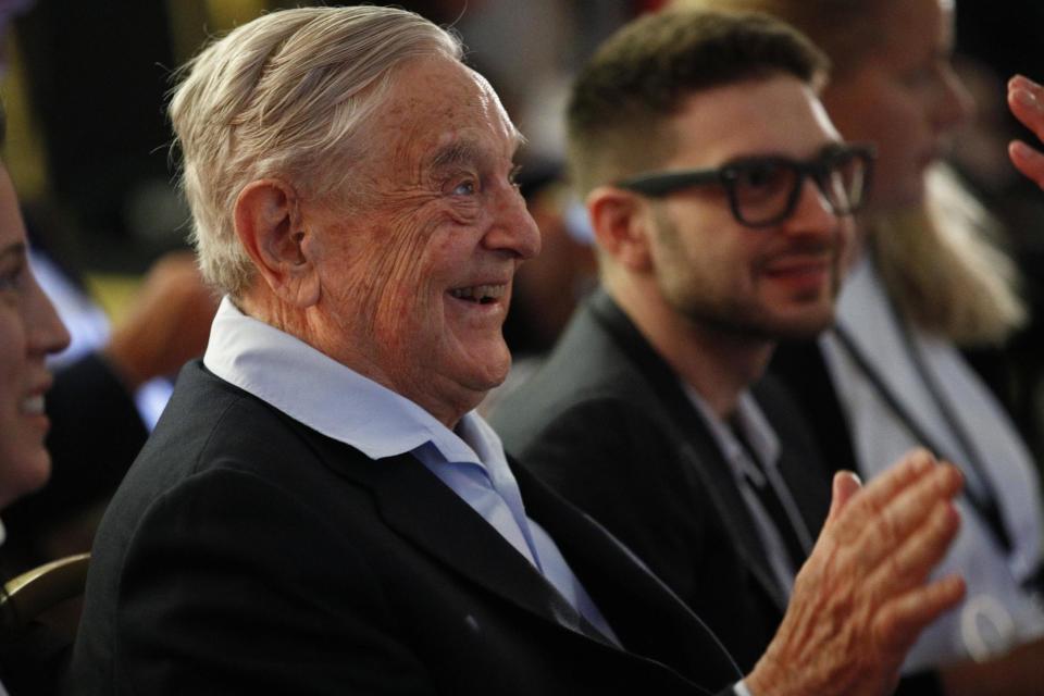 George Soros, left, attends the European Council On Foreign Relations Annual Council Meeting in Paris: AP