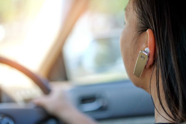 <p> </p><p>S Rawu Th Ni Rothr / EyeEm / Getty Images </p> Stock image of woman with in-ear headphones on driving