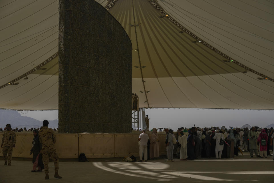 Muslim pilgrims cast stones at pillars in the symbolic stoning of the devil, the last rite of the annual hajj, in Mina, near the holy city of Mecca, Saudi Arabia, Tuesday, June 18, 2024. Muslim pilgrims were wrapping up the Hajj pilgrimage in the deadly summer heat on Tuesday with the third day of the symbolic stoning of the devil, and the farewell circling around Kaaba in Mecca's Grand Mosque. (AP Photo/Rafiq Maqbool)