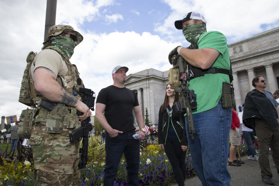 Protestors carrying guns outside the Capitol building in Olympia, Washington.