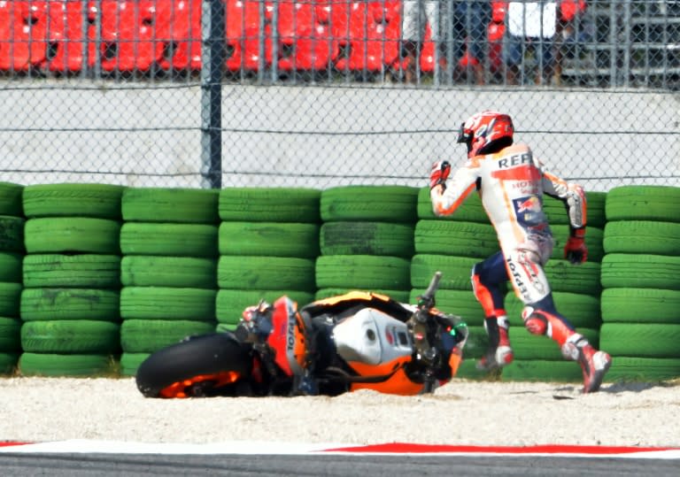 Spanish world champion Marc Marquez races to find a spare bike after falling in qualifying for the San Marino MotoGP Grand Prix