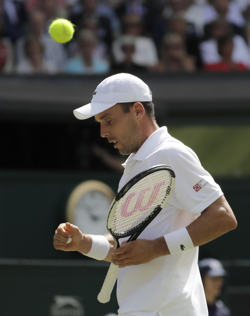 Spain's Roberto Bautista Agut celebrates winning a point in a men's singles semifinal match against Serbia's Novak Djokovic on day eleven of the Wimbledon Tennis Championships in London, Friday, July 12, 2019. (AP Photo/Ben Curtis)