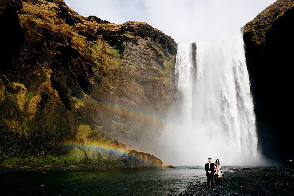 Jinna Yang and a cutout of her father in front of the Skogafoss Falls in Iceland.