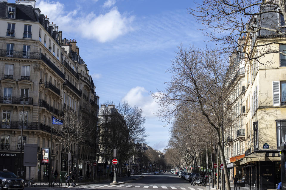 An empty street is pictured Sunday March 15, 2020 in Paris. For most people, the new coronavirus causes only mild or moderate symptoms. For some it can cause more severe illness. (AP Photo/Rafael Yaghobzadeh)