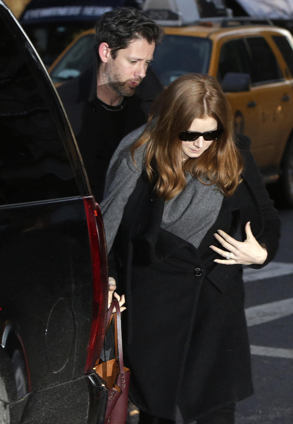 Oscar-nominated actress Amy Adams and her fiancé Darren Le Gallo arrive at a wake for actor Philip Seymour Hoffman at the Frank E. Campbell Funeral Home on Manhattan's Upper East Side, Thursday, Feb. 6, 2014, in New York. Hoffman died Sunday of a suspected drug overdose in his New York apartment. (AP Photo/Kathy Willens)