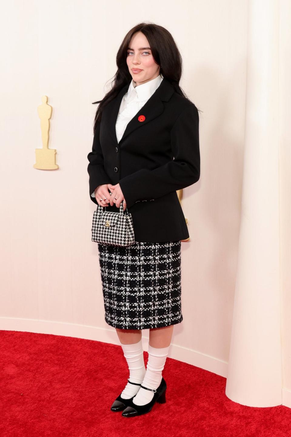 Billie Eilish in Chanel and anArtists4Ceasefire movement red pin (Getty Images)