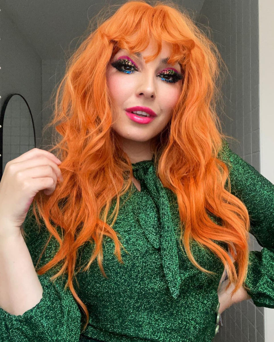 The Block star Tanya Guccione in a bright orange wig and green top