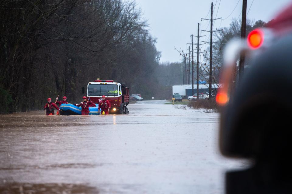 Berea firefighters make their way with a rescue truck through floodwaters carrying workers from Mosaic Color & Additives off of Sulphur Springs Road who were stranded Thursday, February 6, 2020 after heavy rain stranded them at their facility.