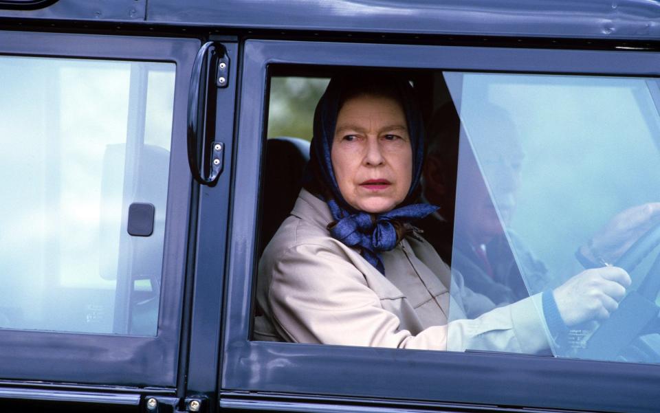 No stranger to the wheel: The Queen drives to the Windsor Horse Show in 1986 - Credit: Rex