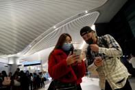 Passengers wearing masks arrive on a direct flight from China at Istanbul International Airport in Istanbul