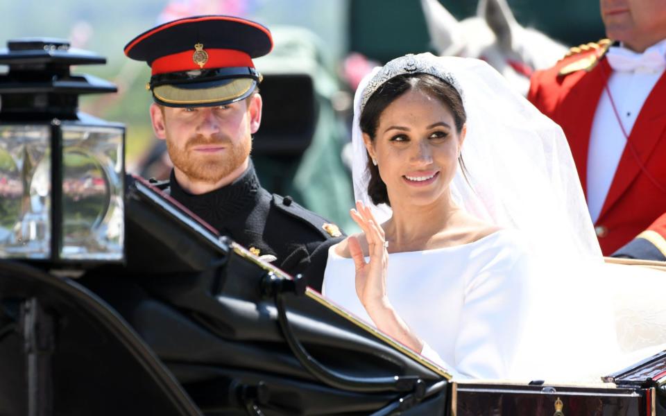 Prince Harry, Duke of Sussex and Meghan, Duchess of Sussex leave Windsor Castle in the Ascot Landau carriage during a procession after getting married at St Georges Chapel on May 19, 2018  - WireImage