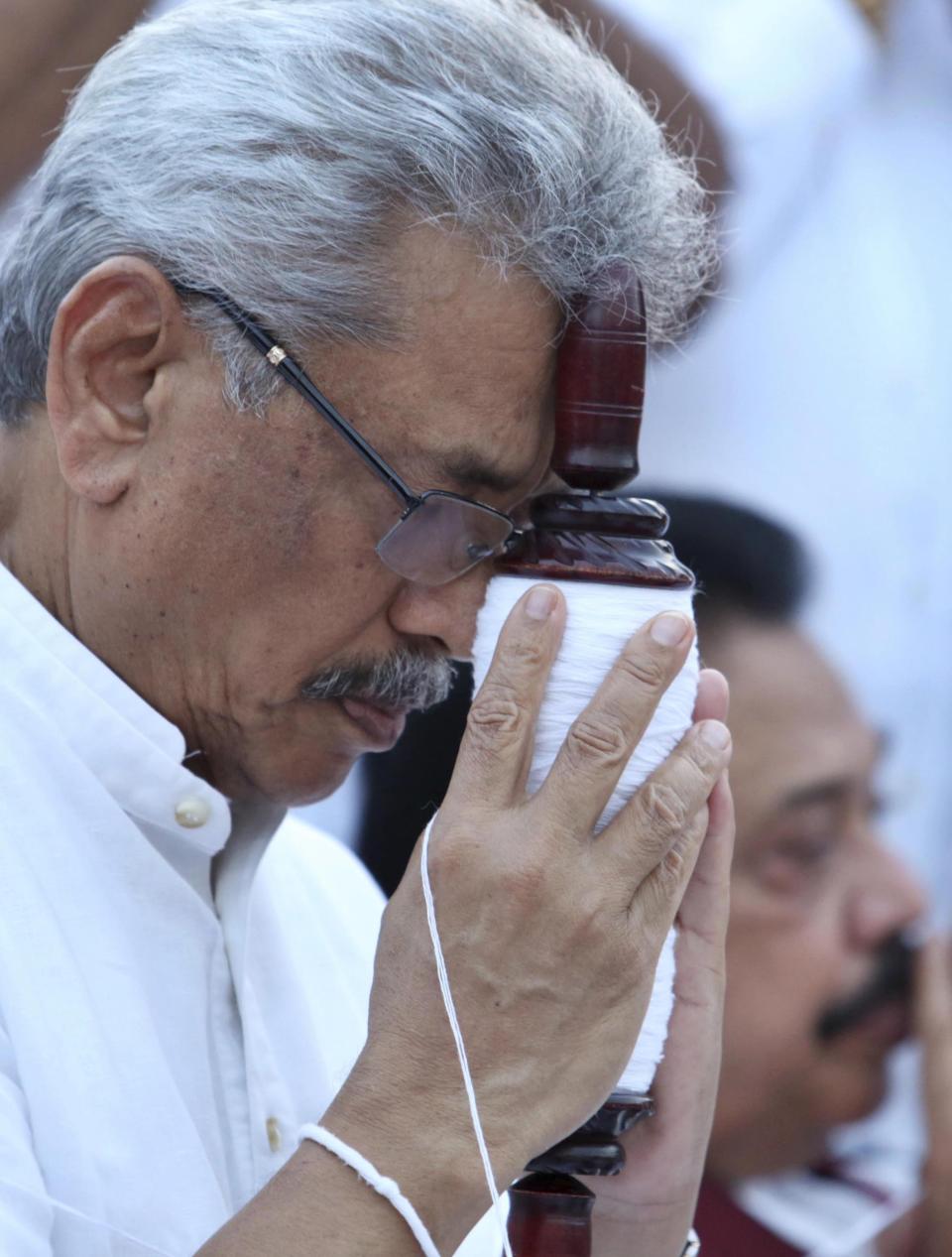 In this Aug 15, 2019, photo, former Sri Lankan Defense Secretary and opposition’s presidential candidate Nandasena Gotabaya Rajapaksa prays at a Buddhist temple during his election campaign in Anuradhapura, Sri Lanka. Gotabaya is a feared former defense official accused of human rights abuses and crushing critics, but to many Sri Lankans, he is the leader most needed after last April’s Easter bomb attacks that killed more than 250 people. (AP Photo/Sajeewa Chinthaka)